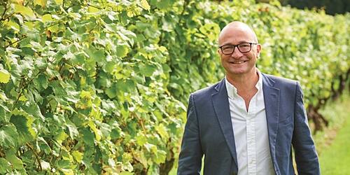 a photo of andrew carter standing in a vineyard